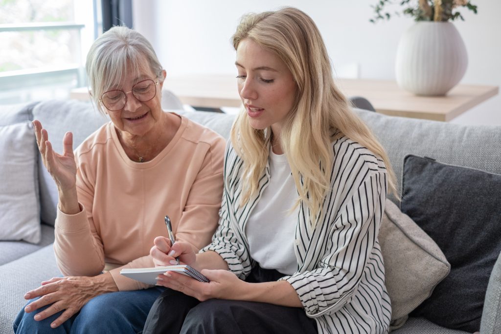 Young,Woman,And,Elderly,Woman,Sit,On,A,Couch,While
